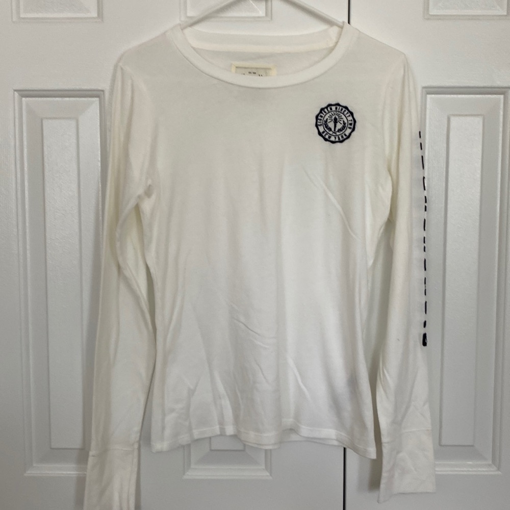 White long sleeve shirt with blue A&F emblem.